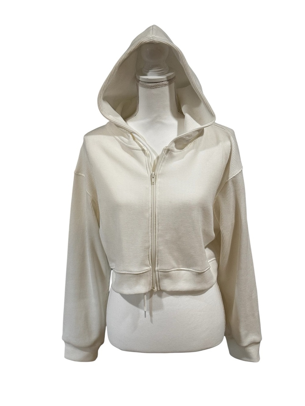 White hooded long sleeved crop zip-up waffle knit sweatshirt, no brand shown, S.